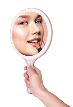 a woman's hand holding a magnifying glass with a lipstick on it