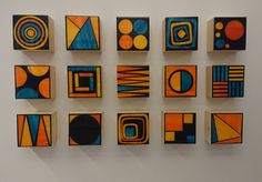 nine abstract paintings are displayed on the wall