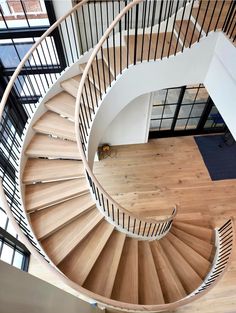 an overhead view of a spiral staircase in a house with wood floors and glass doors