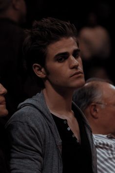 two people sitting next to each other at a basketball game