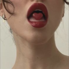 a woman with her mouth open and red lipstick on it's lips is making a funny face