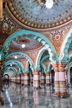 the inside of an ornately decorated building with blue and gold paint on the ceiling