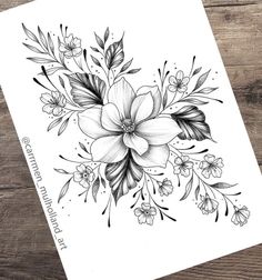 a black and white drawing of flowers on a piece of paper next to a pen