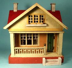 a doll house with a red roof and green door on a blue background is shown