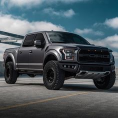 a large gray truck parked on top of a parking lot