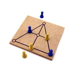 a board game with blue and yellow figures on it, surrounded by small pins in the shape of a triangle