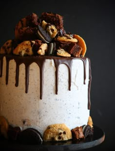 a cake with cookies and chocolate drizzled on top