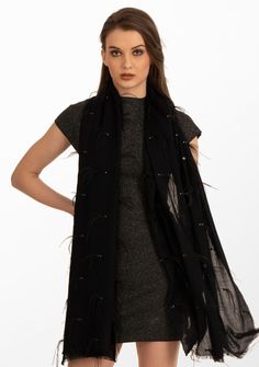 This black scarf is woven from the finest premium cashmere. It is a stunning head-turner adorned with a combination of black ostrich feathers, black sequin and contrasting silver Swarovski crystals scattered across the scarf. Meticulously hand crafted, this scarf is a classic combination of luxury and sophistication. The ostrich feathers add opulence, whilst the scattered sequin and Swarovski crystals bring a subtle yet dazzling allure. Whether draped casually for everyday chic or worn on specia Black Sparkly Scarf, Luxury Black Winter Scarves, Elegant Fall Party Scarves, Elegant Fall Party Scarf, Luxury Black Scarf For Fall, Luxury Black Scarf For Formal Occasions, Elegant Evening Scarves For Winter, Luxury Black Formal Scarves, Elegant Evening Scarf For Winter