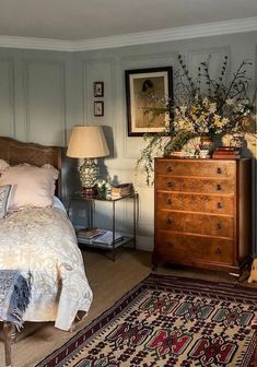 a bed room with a neatly made bed and a rug