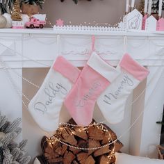 two stockings that say daddy and me hanging from a fireplace mantel with christmas lights