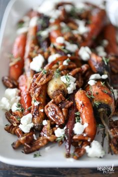 carrots, goat cheese and pecans on a white plate