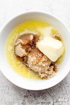 a white bowl filled with food on top of a table