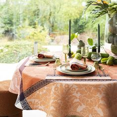 the table is set with place settings for two people to sit down and enjoy their meal