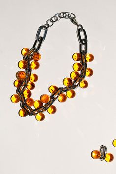 A chunky, linked statement necklace punctuated with amber colored beads. About 19" long including the clasps. Elegant Orange Jewelry With Chain, Elegant Orange Chain Jewelry, Bold Orange Party Jewelry, Chunky Beaded Necklace, Saturn Necklace, Chunky Bead Necklaces, Bead Necklaces, Chunky Beads, Amber Color