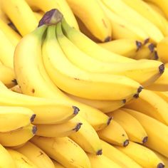 several bunches of bananas sitting on top of each other