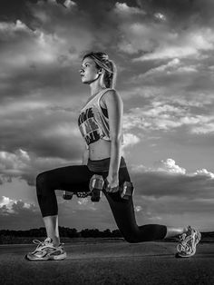 a black and white photo of a woman running