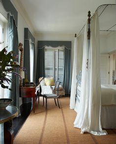 a bed room with a neatly made bed and curtains