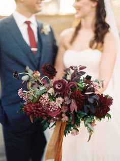 a bride and groom standing next to each other