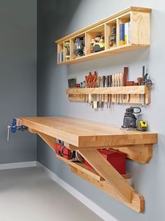 a workbench made out of plywood with tools on the shelf above it