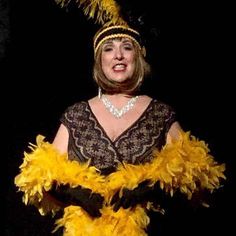 a woman in a costume with feathers on her head and hands out to the side