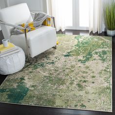 a living room with a white chair and green rug