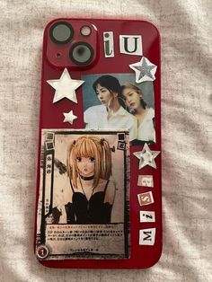 a cell phone case with pictures and stars on the back, sitting on a bed