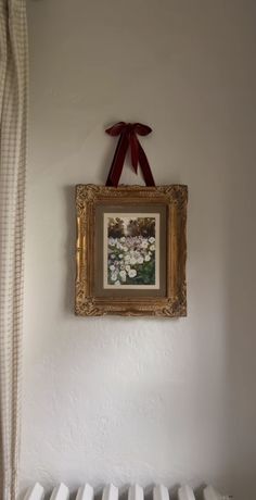 a painting hanging on the wall above a radiator