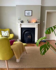 a living room filled with furniture and a fire place next to a fireplace on top of a hard wood floor