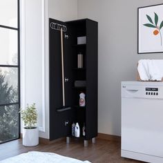 a white and black cabinet in the corner of a room