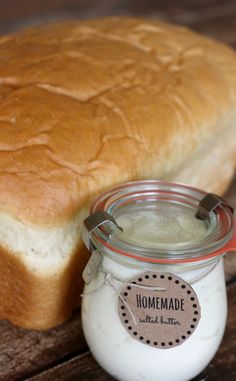 a loaf of bread sitting next to a jar of yogurt