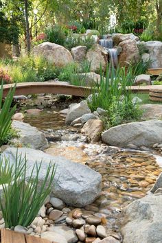 there is a small waterfall in the middle of this garden