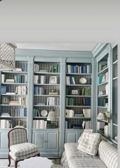 a living room filled with lots of blue bookshelves and furniture next to each other