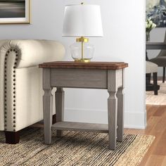 a living room scene with focus on the end table and chair in the foreground