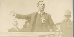 an old black and white photo of a man speaking