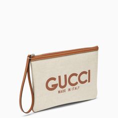 Beige cotton-blend pouch by Gucci features zipper and drawstring closure, beige and ebony GG fabric interior and contrasting lettering logo on front. Width 29 cm x Height 19,5 cm x Depth 1 cm Size Type: INTMaterial: CottonSKU: 777165FACUL/O_GUC-8451_100 Our Products Are 100% Genuine. In All Cases We Stand By The Authenticity Of Every Product Sold On Our Site. Gucci Coated Canvas Shoulder Bag With Removable Pouch, Gucci Beige Signature Coated Canvas Bag, Gucci Beige Pouch Bag, Gucci Coated Canvas Bag With Logo, Gucci Canvas Bags With Gold-tone Hardware, Lettering Logo, Bottega Veneta Shoulder Bag, Louis Vuitton Shoulder Bag, Chanel Handbags