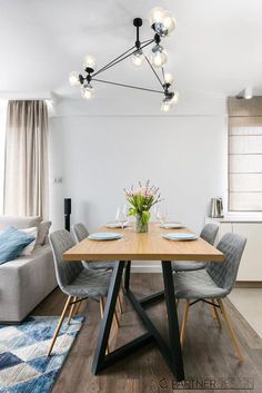 a dining room table and chairs in front of a couch