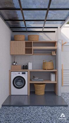 a washer and dryer in a small room with shelves on the wall next to it