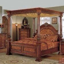 a bedroom with a canopy bed, dresser and mirror