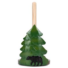 a green tree with a black bear on it and a wooden stick sticking out of the top