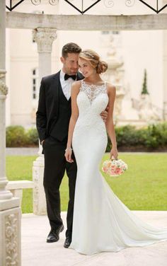 a bride and groom standing in front of a gazebo