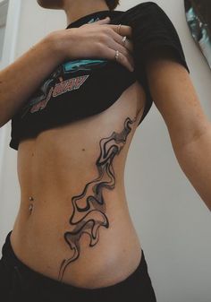 a woman with a tattoo on her stomach