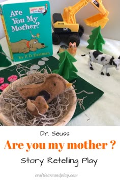 there are toys and books on the bed with text that reads are you my mother? story retelling play