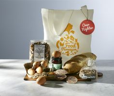 an assortment of bread, eggs and condiments sitting on a counter next to a bag