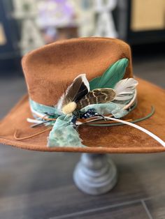 Perfect custom cowboy hat with branded boots and cactus. Custom hat band, feathers and stitches with bandanna  Size medium Handmade Hat Bands For Kentucky Derby, Bohemian Felt Hat For Western-themed Fall Events, Western Hat Bands With Feather Trim And Curved Brim, Western Hats With Feathers For Ranch, Custom Hats With Feathers For Rodeo, Western Ranch Hats With Feathers, Custom Feather Hat Bands For Country Events, Western Fedora With Feathers And Flat Brim, Western Brown Hat Band With Feather Trim