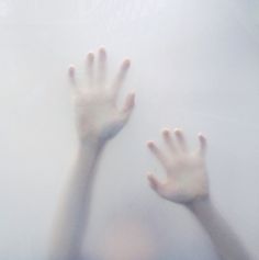 two hands reaching for something in the fog