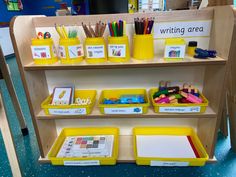 the shelves are filled with different colored pencils and writing materials for children to use