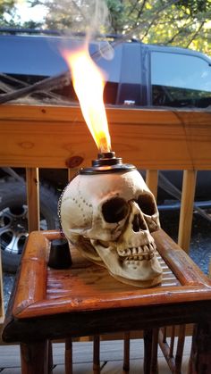 a skull lamp on top of a wooden table