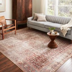 a living room filled with furniture and a large rug