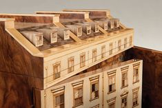 a wooden model of a building with windows