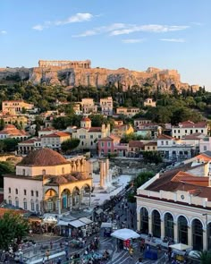 an aerial view of the acrobatic city of athens, with part of the acrylid hill in the background